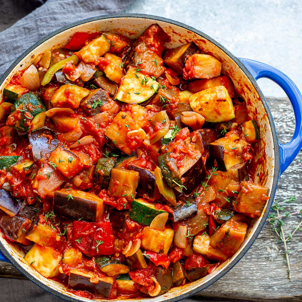 Ratatouille in a large blue pan.